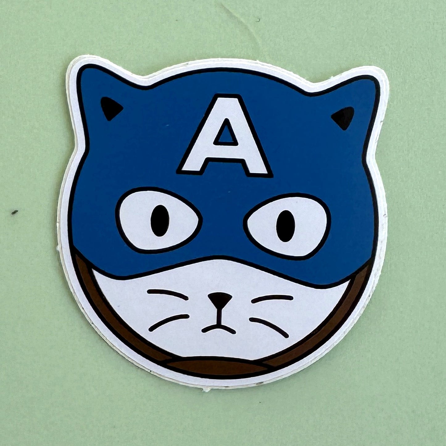 Cat-Pin America sticker - kawaii cat with blue Captain America mask and white A on forehead