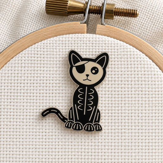 Skeleton Cat Needle Minder on an embroidery hoop, pirate skeleton cat with an eyepatch, gold finish