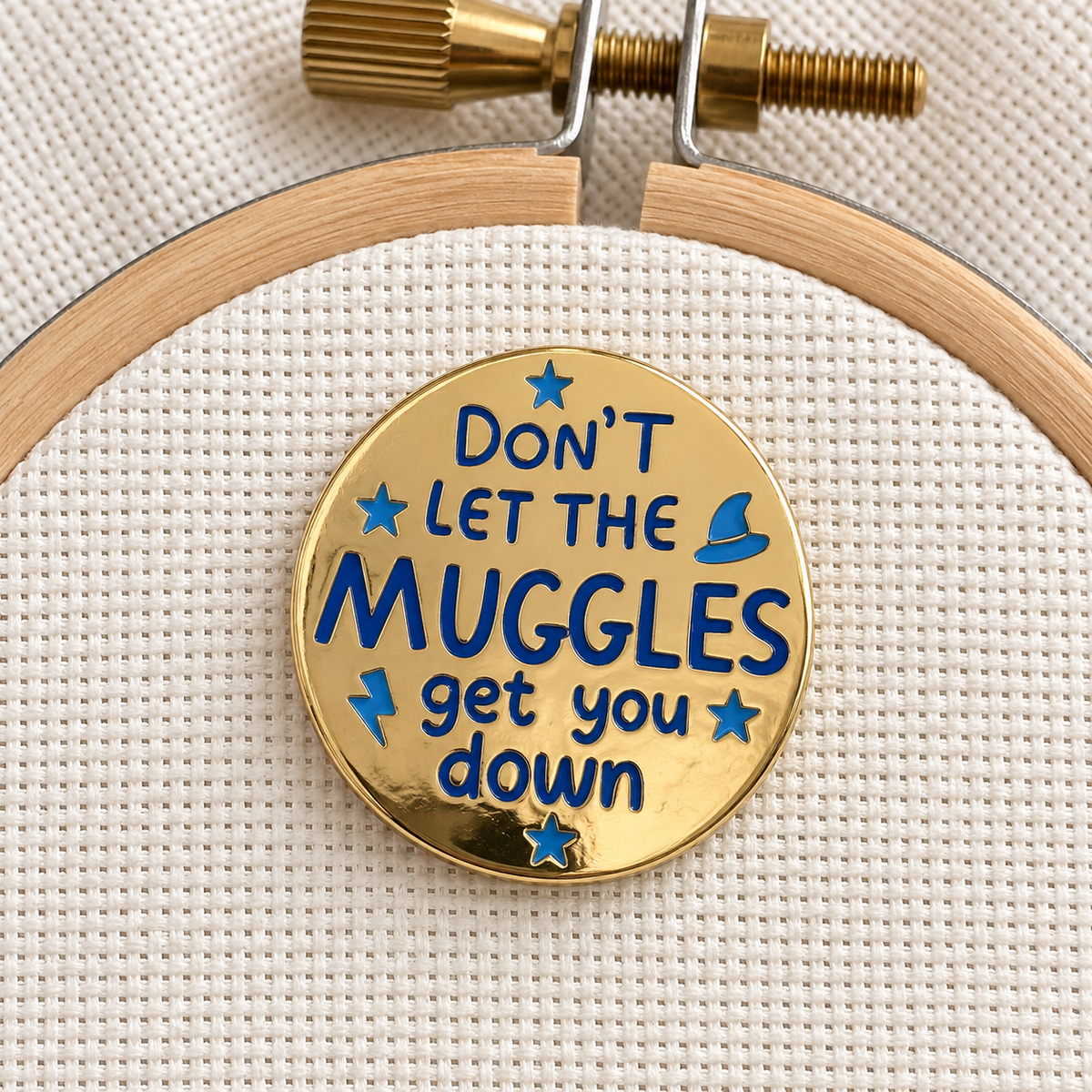 Don't Let the Muggles Get You Down Needle Minder, gold with blue lettering
