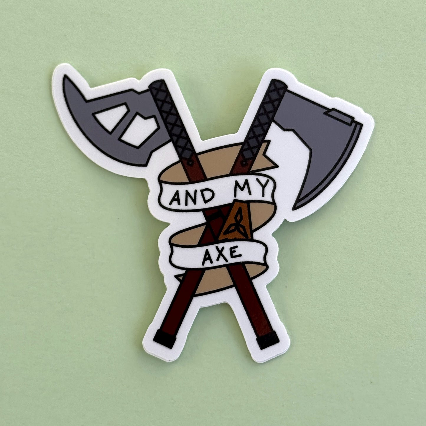 And My Axe sticker on green - crossed axe and machete with 'And My Axe' banner