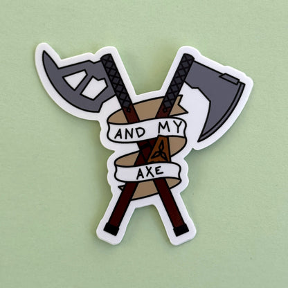 And My Axe sticker on green - crossed axe and machete with 'And My Axe' banner