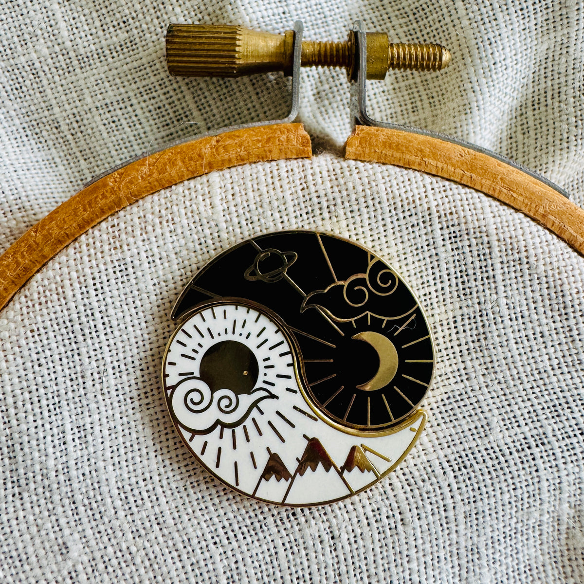 Night and Day Needle Minder Set on an embroidery hoop, sun and moon halves joined