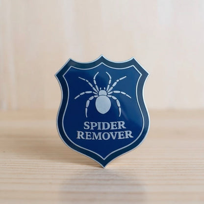 Spider remover second-grade enamel pin on its backing card