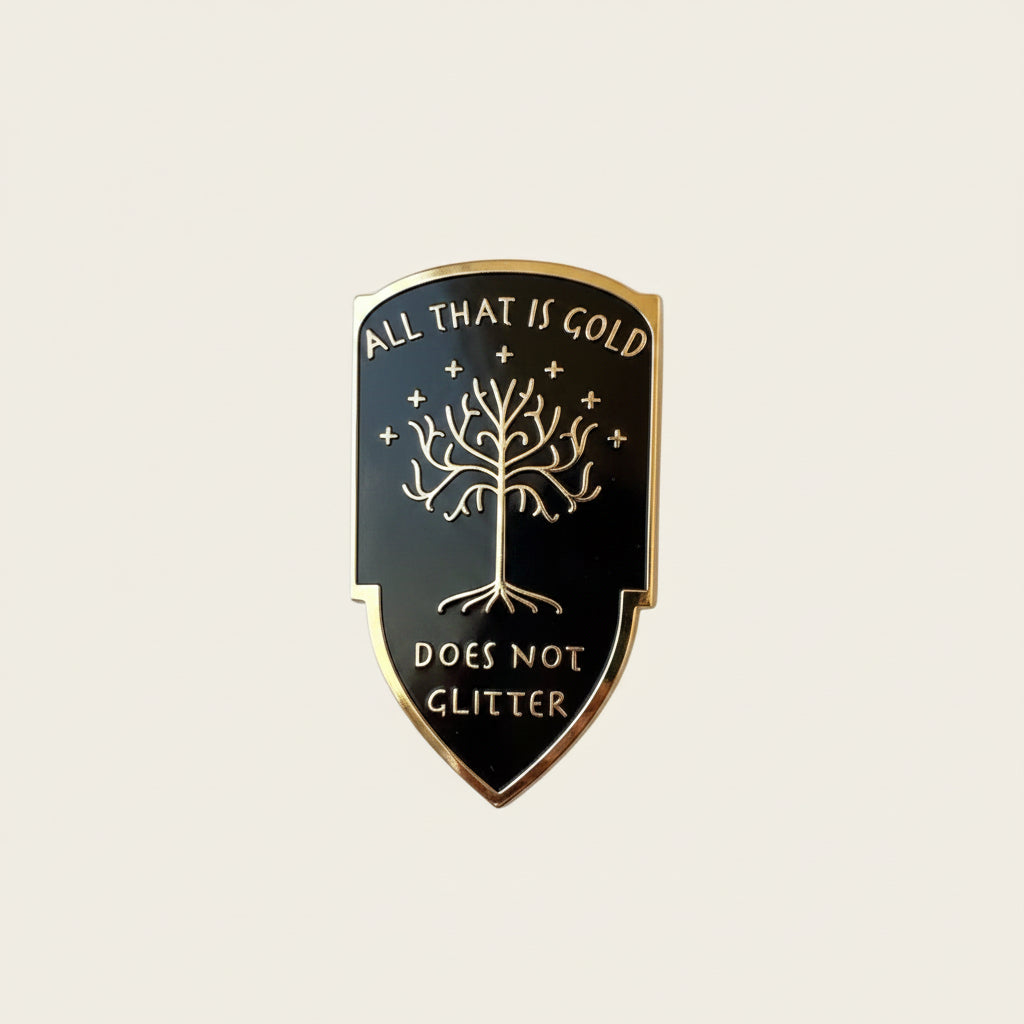 All That is Gold Does Not Glitter pin — black shield with the White Tree of Gondor, surrounded by gold leaves and sparkles on white background