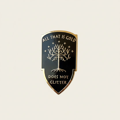 All That is Gold Does Not Glitter pin — black shield with the White Tree of Gondor, surrounded by gold leaves and sparkles on white background