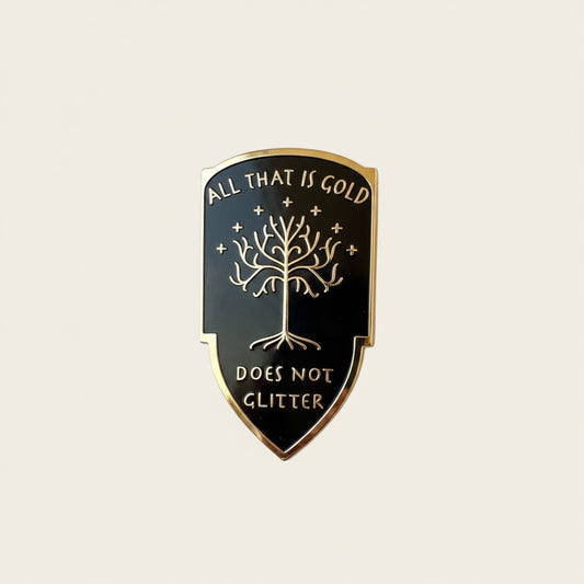 All That is Gold Does Not Glitter pin — black shield with the White Tree of Gondor, surrounded by gold leaves and sparkles on white background