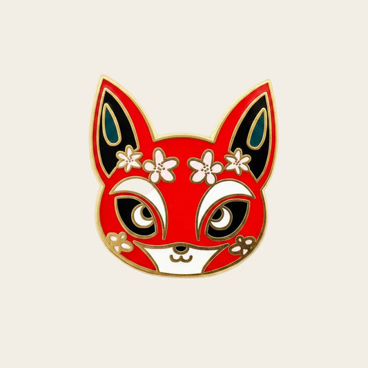 Fox kitsune festival mask enamel pin: red face, white snout, sakura crown, gold plating