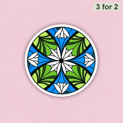 Elven Stained Glass Sticker, round clear sticker of green and blue stained glass with white flowers, held up to the sky, LOTR sticker