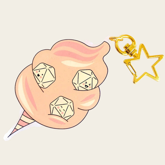 Fairy Floss Dice Charm — clear acrylic charm of pink/peach fairy floss (cotton candy) with three smiling d20s tucked inside, gold star keyring. D&D dice charm in kawaii style on white background.