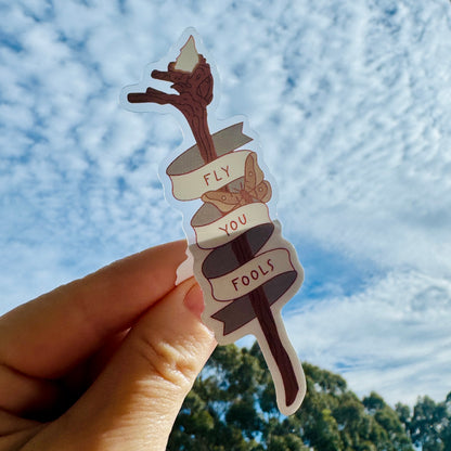 Fly You Fools Sticker held up against the sky to show the clear vinyl, LOTR sticker