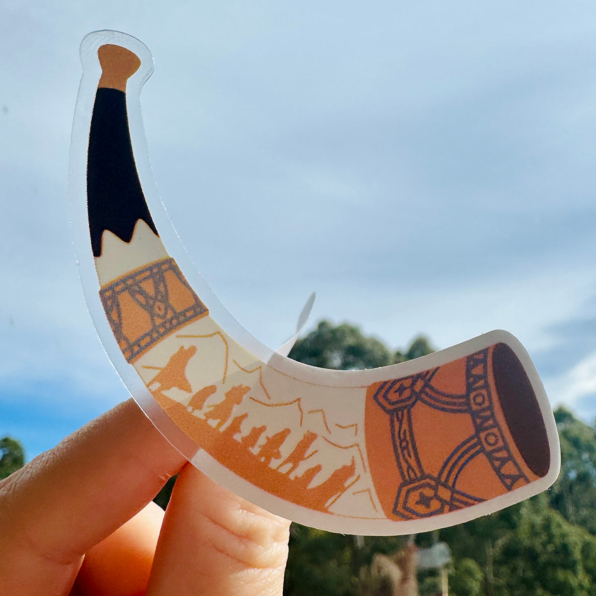 Horn of Gondor Sticker held up against the sky to show the clear vinyl, LOTR sticker