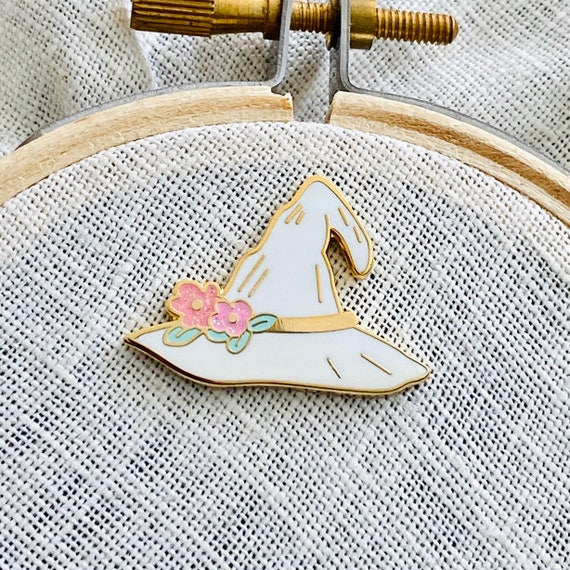 Magic Blossom Witch Hat Needle Minder, white, on an embroidery hoop