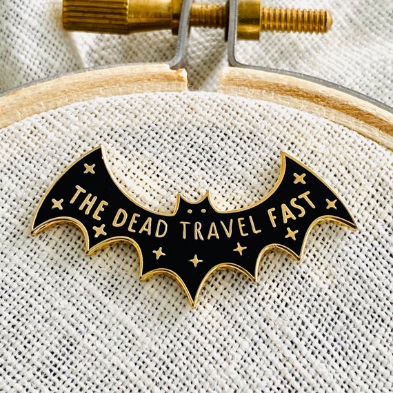 The Dead Travel Fast Needle Minder, black and gold bat on an embroidery hoop