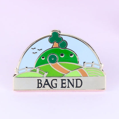 Bag End Needle Minder, gold finish enamel needle minder of Bag End with its name banner