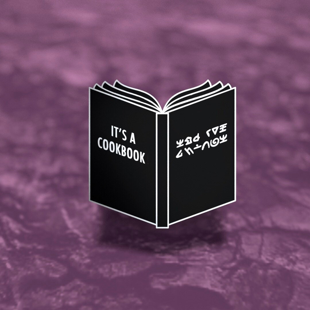 It's a Cookbook enamel pin, black book with alien writing, silver plated, Second