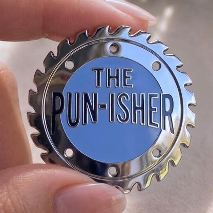 The Pun-isher enamel pin, silver saw blade with blue centre, funny pun dad joke gift