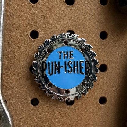 The Pun-isher enamel pin, silver saw blade with blue centre, funny pun dad joke gift