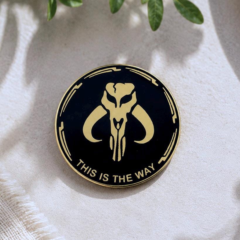 This is the Way enamel pin, gold Mythosaur skull on black, Mandalorian Star Wars pin