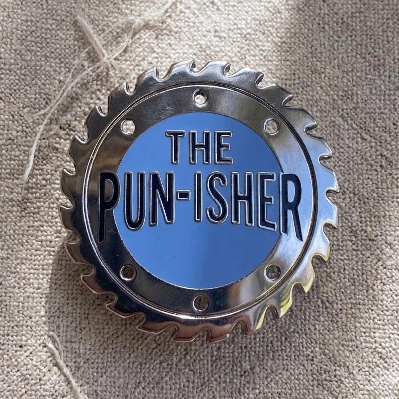 The Pun-isher enamel pin, silver saw blade with blue centre, funny pun dad joke gift
