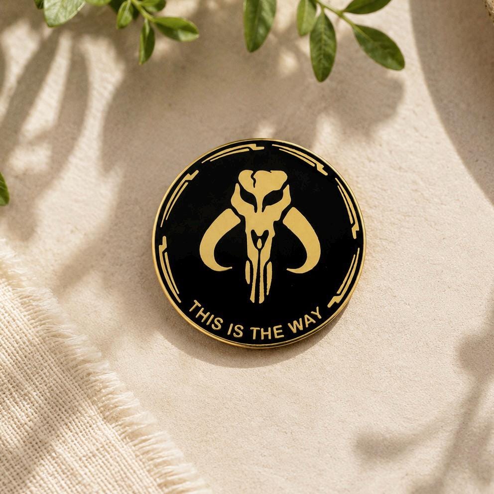 This is the Way enamel pin, gold Mythosaur skull on black, Mandalorian Star Wars pin