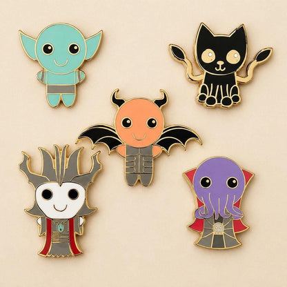 Five kawaii monster enamel pins: goblin, brain-eater, shadow panther, lich and demon