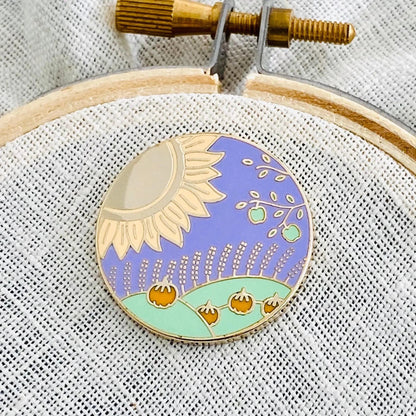 Lammas Needle Minder on an embroidery hoop, sunflower, wheat and apple tree sabbat design with gold finish