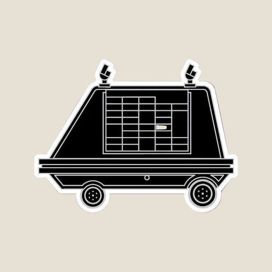 Mouse Droid sticker — black low boxy droid with grid window and two wheels, white sticker border, on a soft pink background. Star Wars droid sticker.