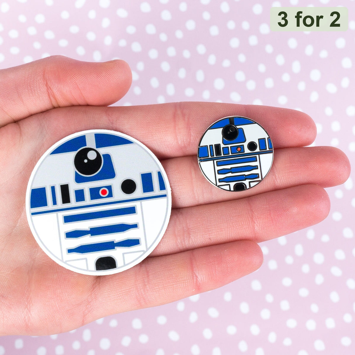 R2-D2 Sticker, blue and white astromech droid sticker held in hand next to the small R2-D2 pin